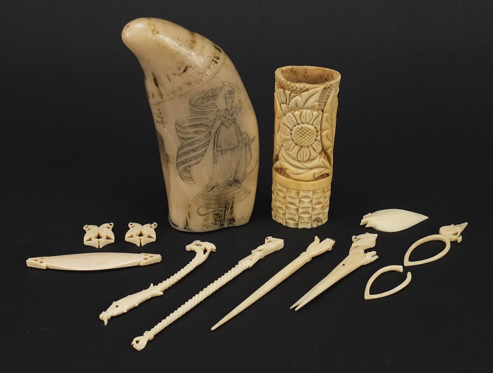 Ivory and bone objects including scrimshaw, the largest 13cm in length