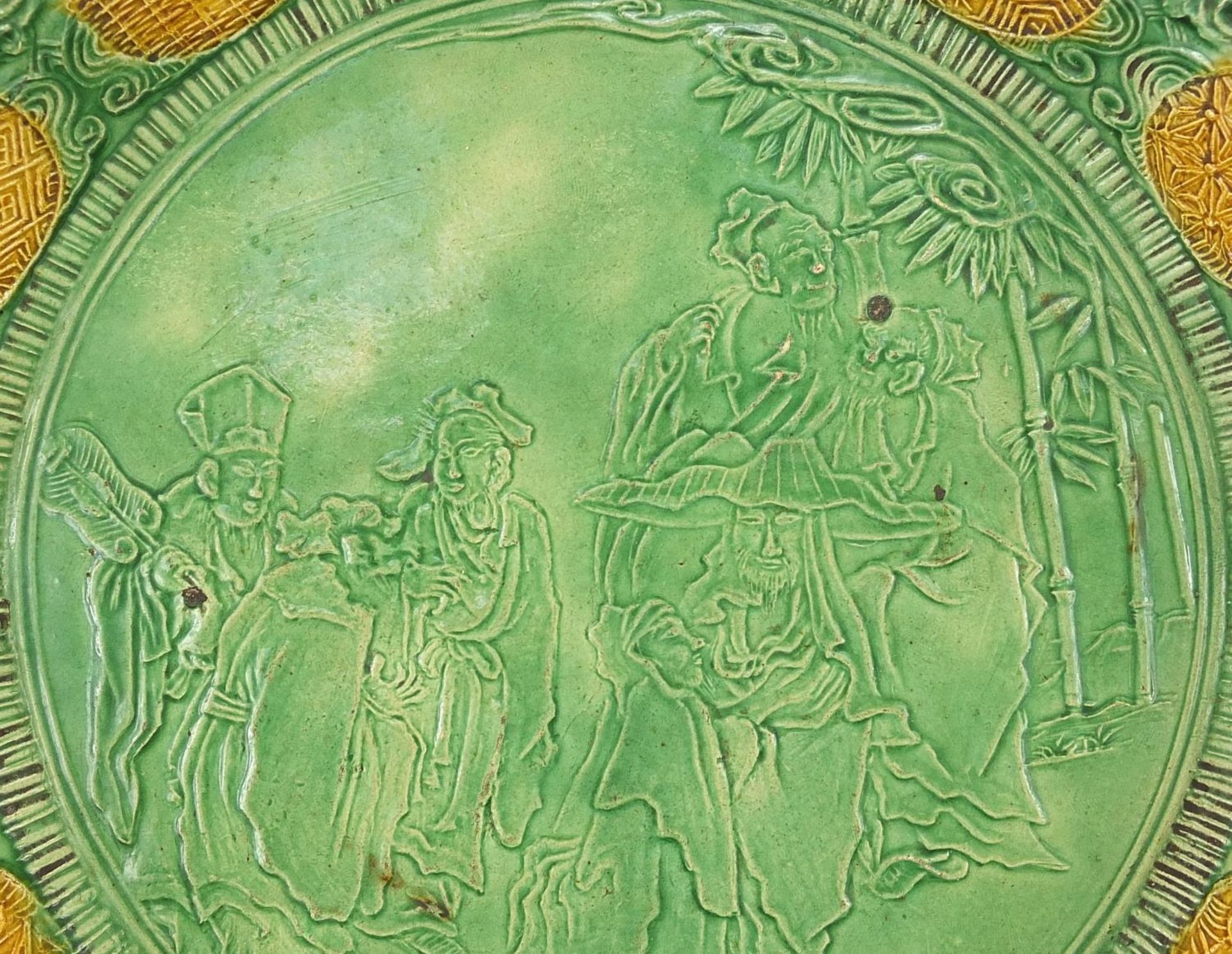 Chinese green and yellow glazed porcelain dish decorated in relief with figures in a palace setting, - Image 2 of 5