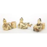 Three Japanese carved ivory netsukes comprising musician, scholar and log carrier, character marks