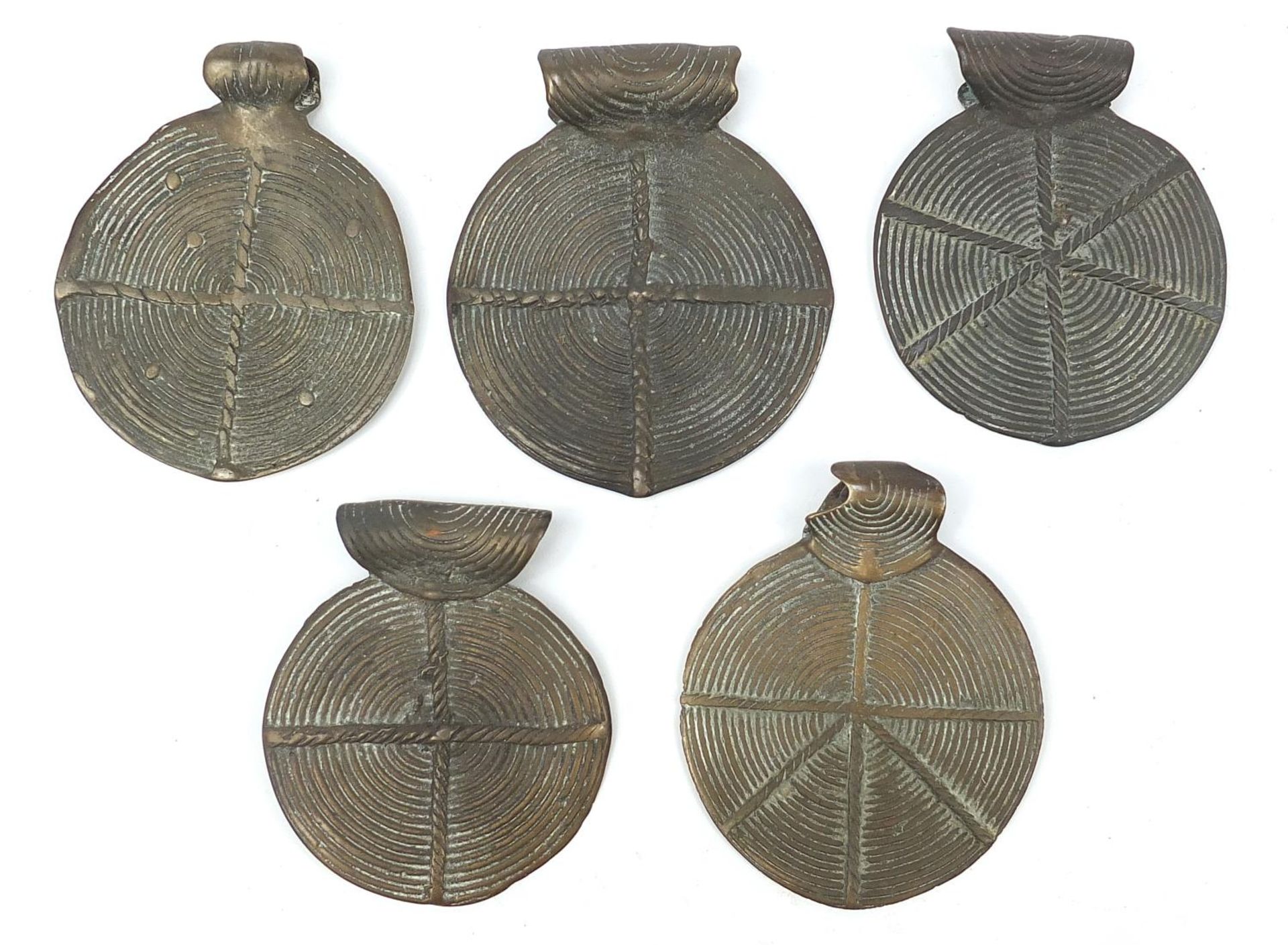Five African Benin style bronze talismans, the largest 11cm high