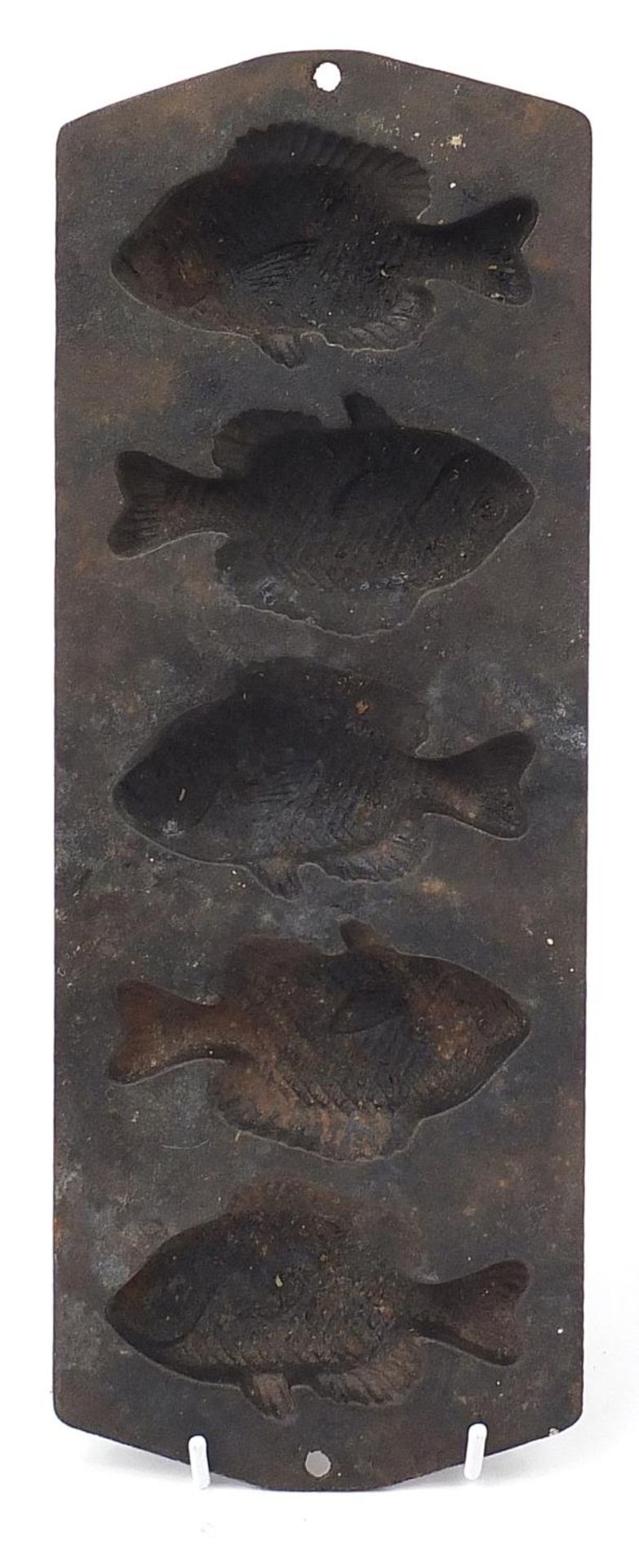 Cast iron butter mould in the shape of five fish, 39cm in length