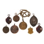 Eight medallions including one with Jesus Christ dated 1862 and one awarded by Charles Atlas to R