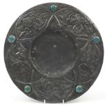 Arts & Crafts metal wall charger with embossed pewter overlay having five Ruskin type cabochons,