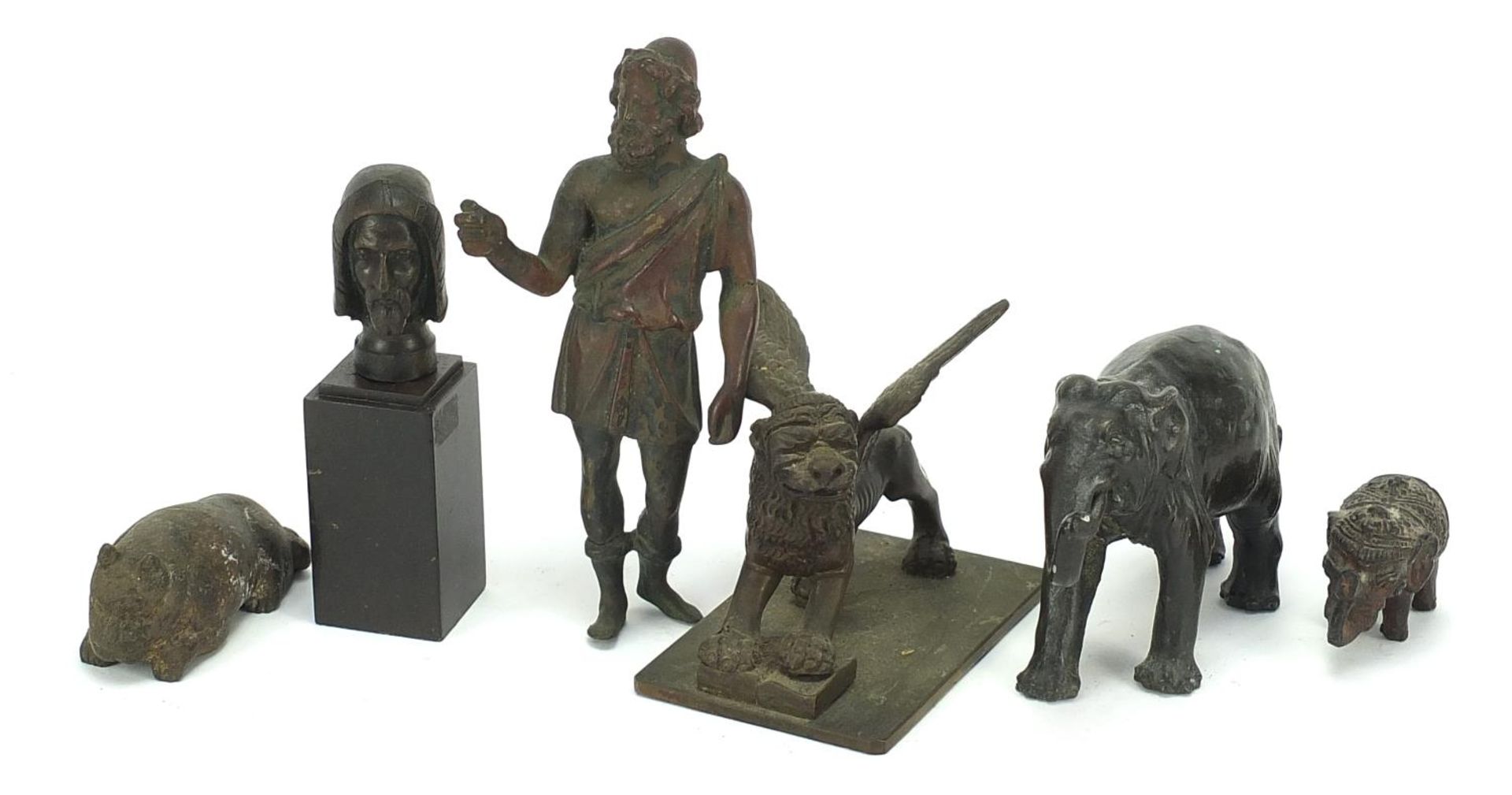 Antique Bronzes to include elephant, Greek figure, lion and a winged mythical beast, the largest