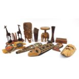 Tribal wood carvings to include African face masks, stool, giraffe bookends, carved box, the largest