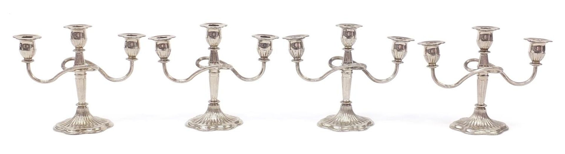 Two pairs of three branch candelabras, 21cm high