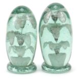 Two Victorian green glass dumps with flowers to the interior, the largest 12cm high