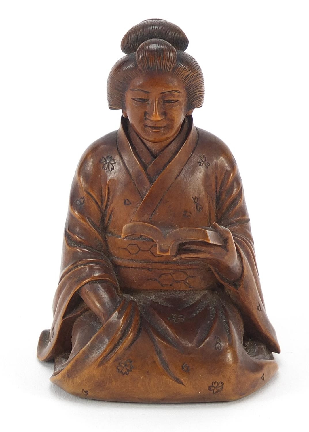 Japanese erotic carved hardwood okimono of a lady kneeling down reading a book, character mark to - Image 2 of 8