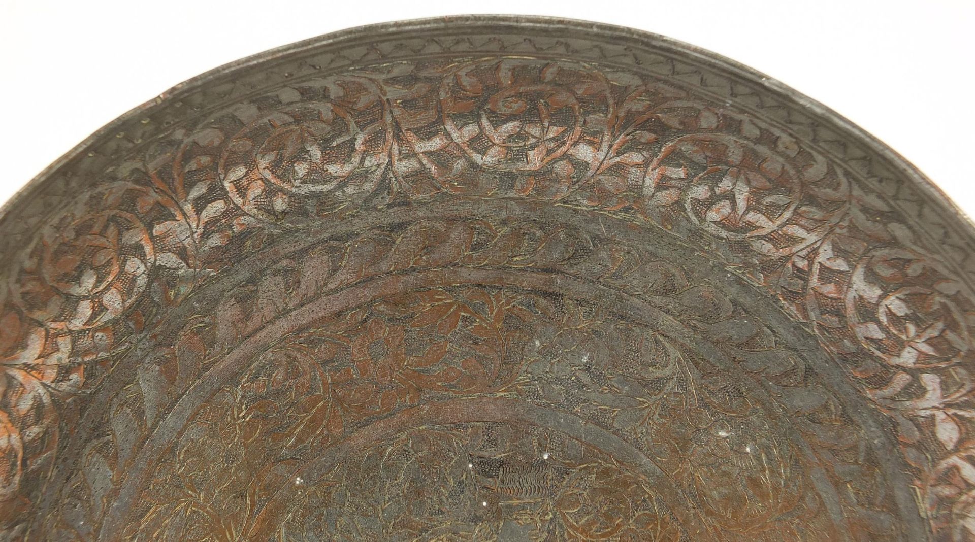 Turkish silvered copper dish engraved with a figure seated in the centre surrounded by flowers and - Image 3 of 5