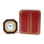 Cartier red and gold coloured desk strut clock, the dial having Roman numerals, housed in a red