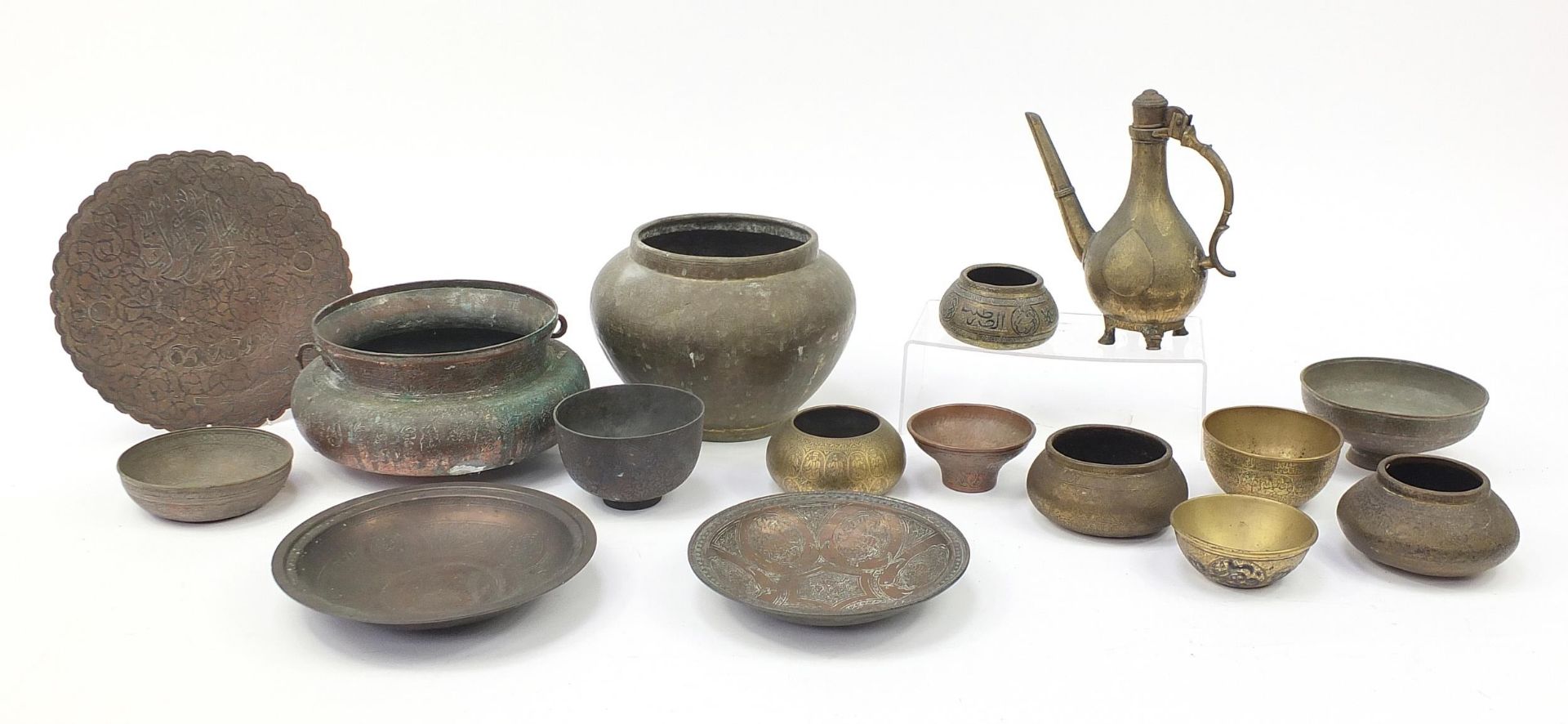 Indian, Islamic and Persian metalware, some with silver inlay including water pot, bowls and dishes,