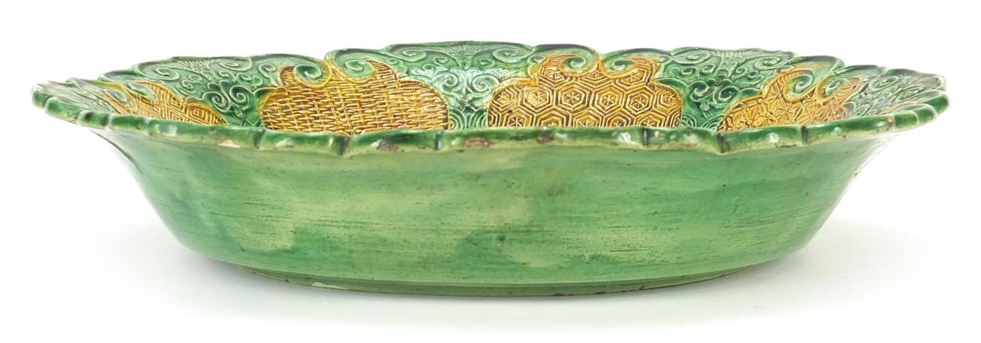 Chinese green and yellow glazed porcelain dish decorated in relief with figures in a palace setting, - Image 3 of 5