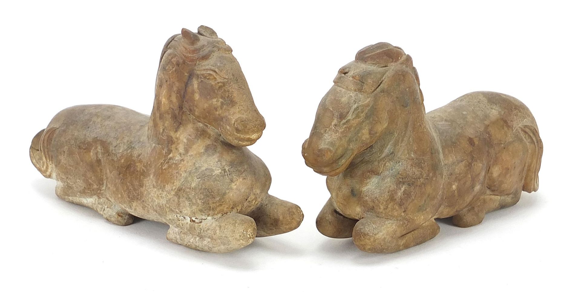 Pair of Chinese carved hardstone recumbent horses, possibly jade, the largest 12cm in length