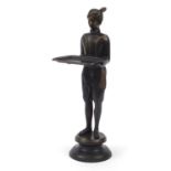 Patinated bronzed dumb waiter in the style of Blackamoor raised on a bronze circular base, 58cm high