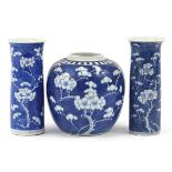 Chinese blue and white porcelain hand painted with prunus flowers comprising two cylindrical vases