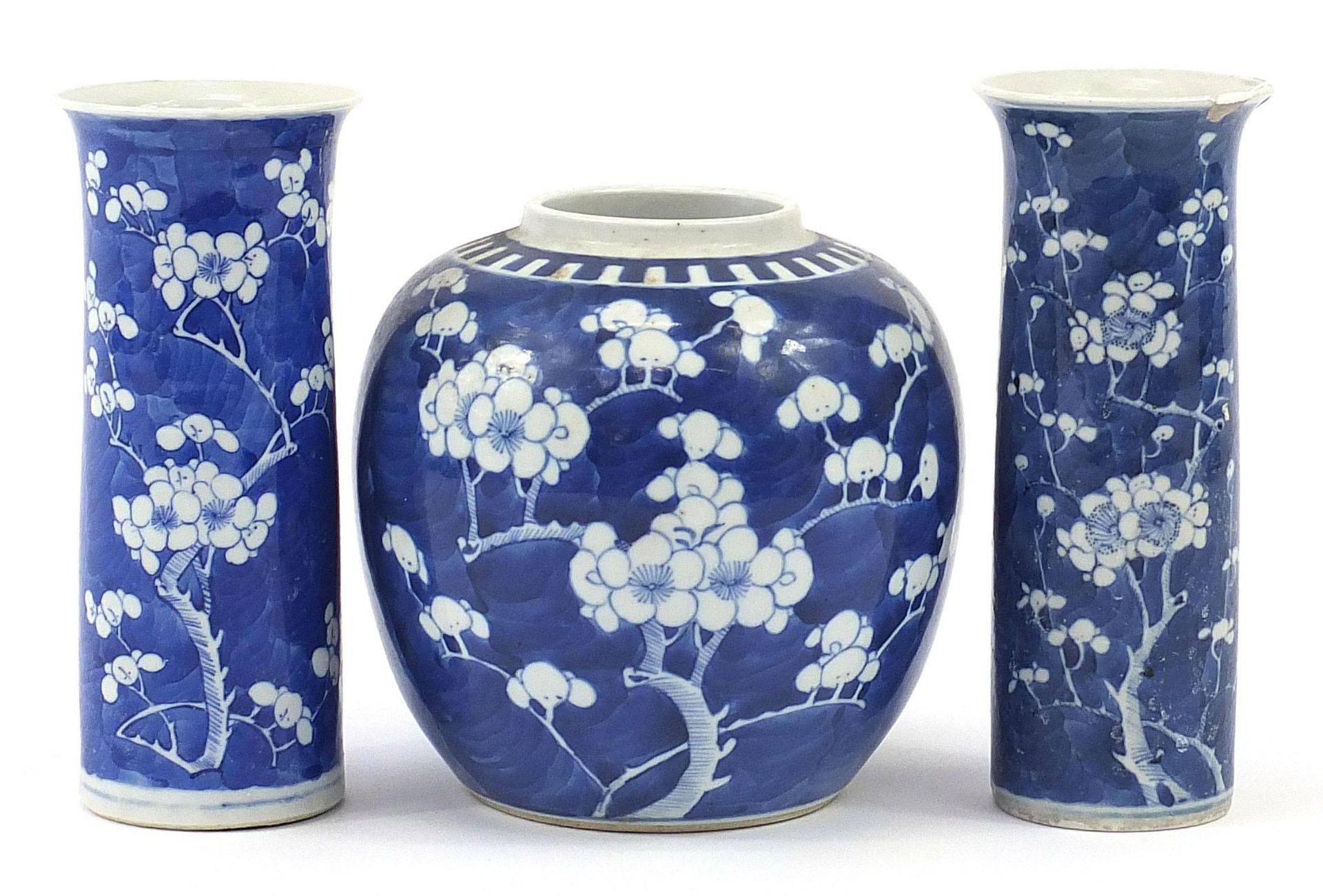 Chinese blue and white porcelain hand painted with prunus flowers comprising two cylindrical vases