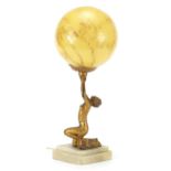 Art Deco table lamp with a glass shade, in the form of a crouching young lady looking up at the