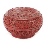 Chinese cinnabar lacquer bun box and cover carved with figures amongst pagodas, 10cm high x 15cm