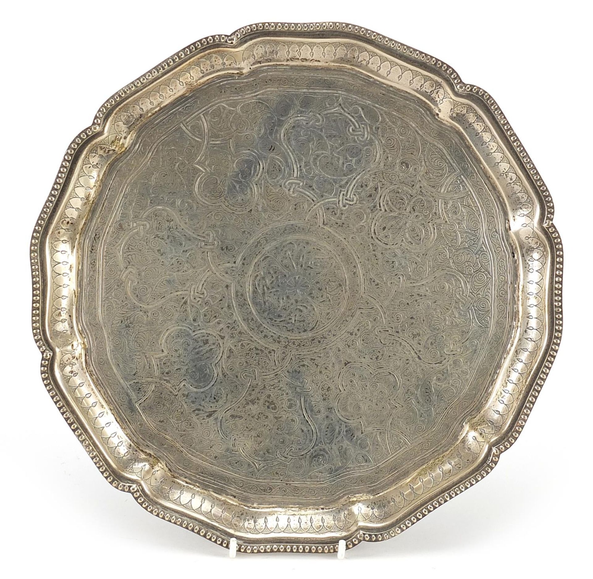 Egyptian circular silver salver with profusely engraved decoration, 28cm in diameter, 632.5g