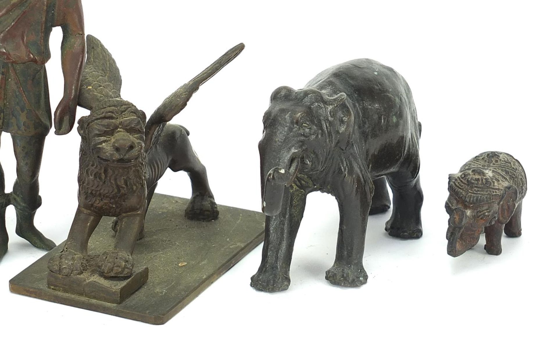 Antique Bronzes to include elephant, Greek figure, lion and a winged mythical beast, the largest - Image 3 of 5