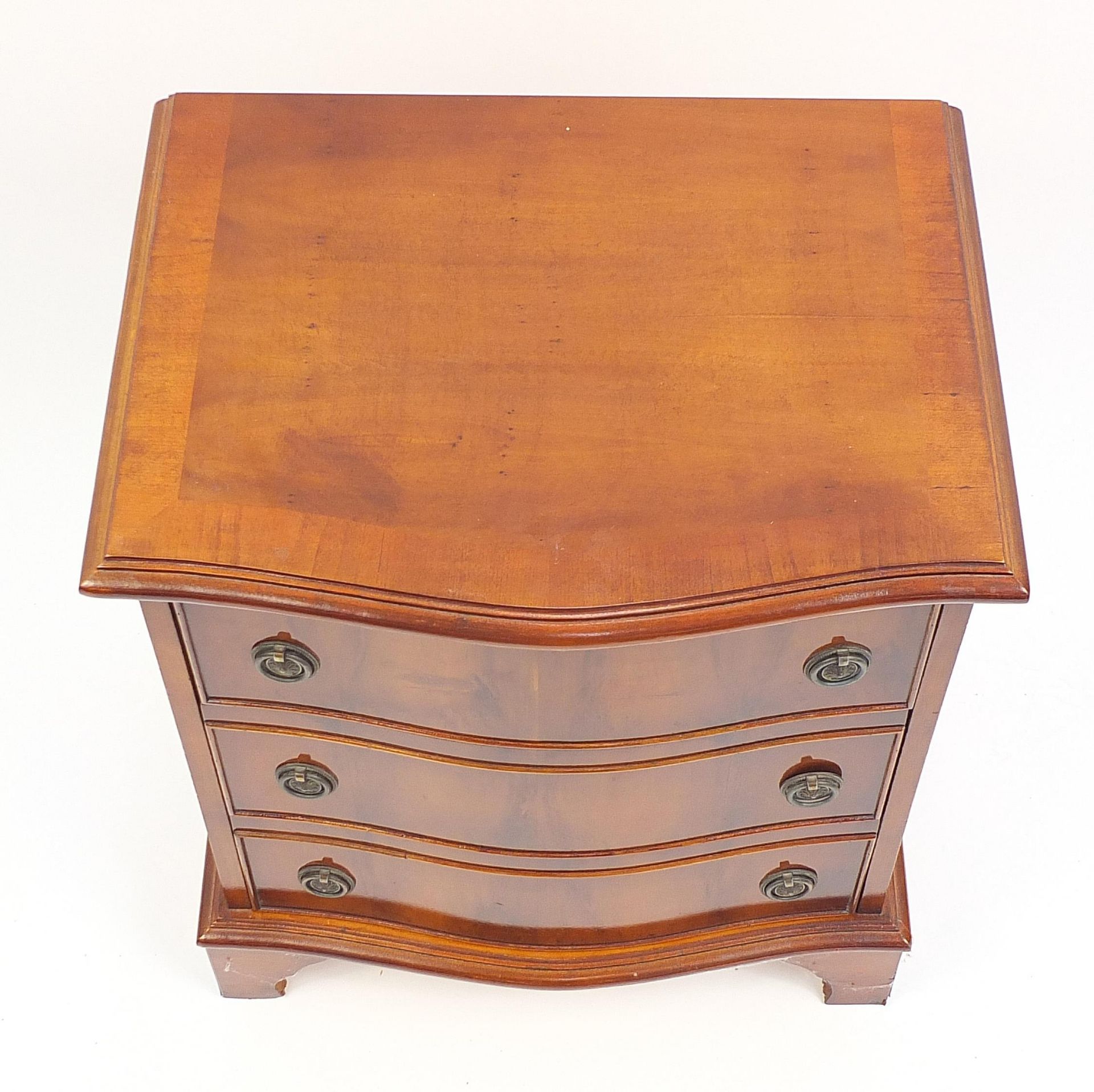 Cross banded yew wood three drawer chest with serpentine front, 57cm H x 50cm W x 39cm D - Image 3 of 4