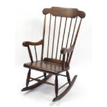 Stained wood stick back rocking chair, 105cm high