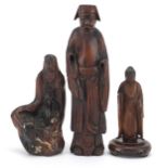 Three Chinese wood carvings including one of an elder and one of standing Buddha, the largest 19.5cm