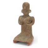 South American pottery figure of a nude figure kneeling, 40.5cm high