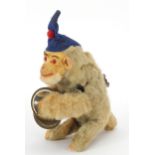 Vintage wind up monkey playing the cymbals, the monkey wearing a blue hat, 20cm high
