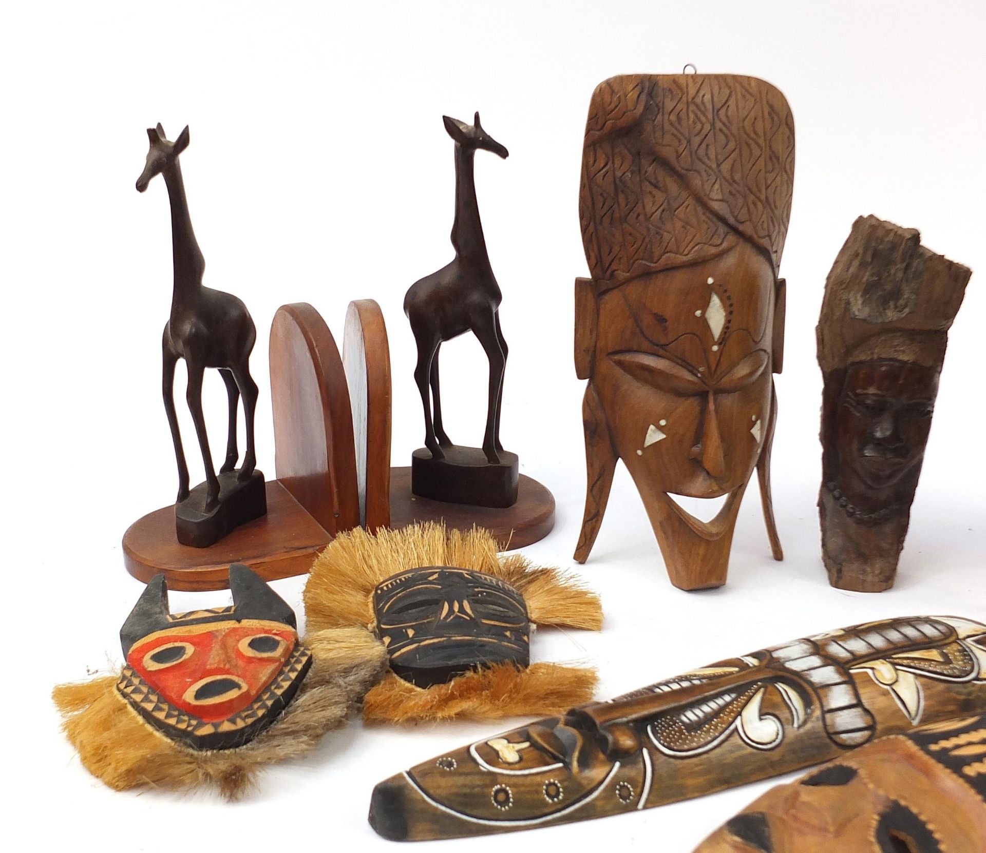 Tribal wood carvings to include African face masks, stool, giraffe bookends, carved box, the largest - Image 2 of 5