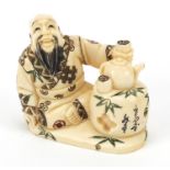 Japanese ivory netsuke of a tea seller sitting down drinking tea, character marks to the base, 4cm
