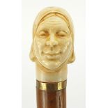 Hardwood and ebony walking stick with carved ivory pommel in the form of a lady's head, 90cm in