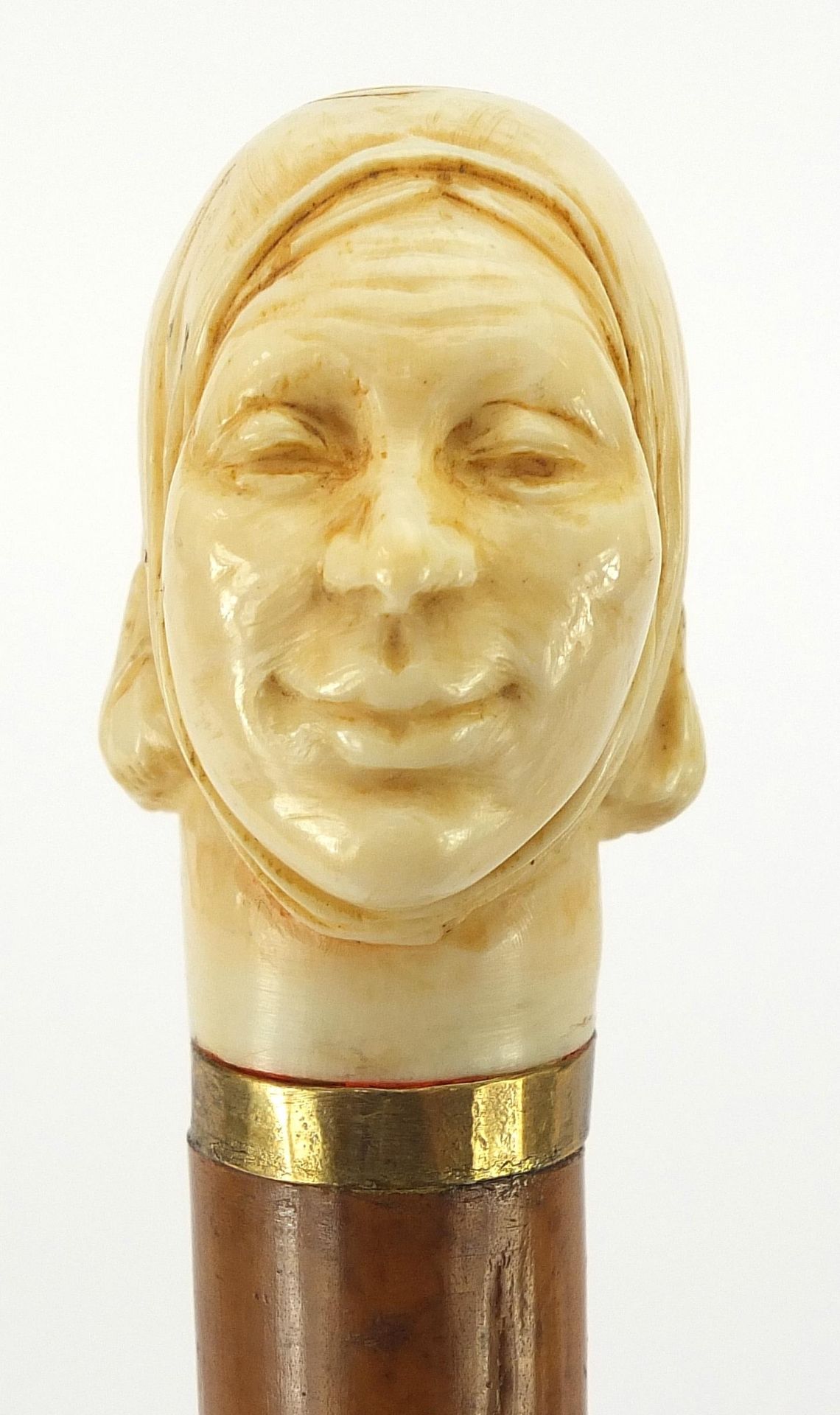Hardwood and ebony walking stick with carved ivory pommel in the form of a lady's head, 90cm in