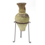 Grecian terracotta amphora with one single handle on a wrought iron stand, 75cm high