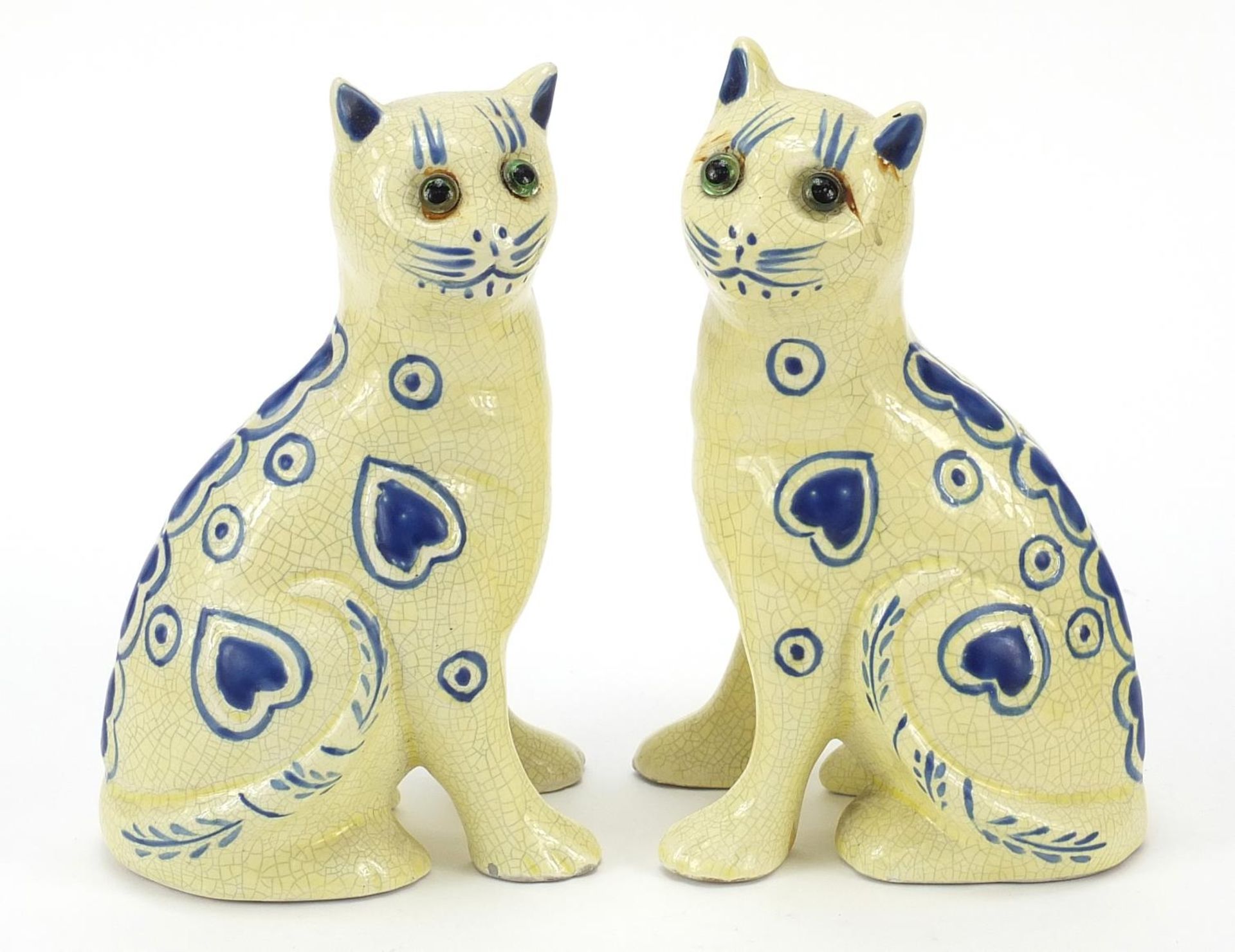 Two Galle style pottery cats with glass eyes, 14cm high