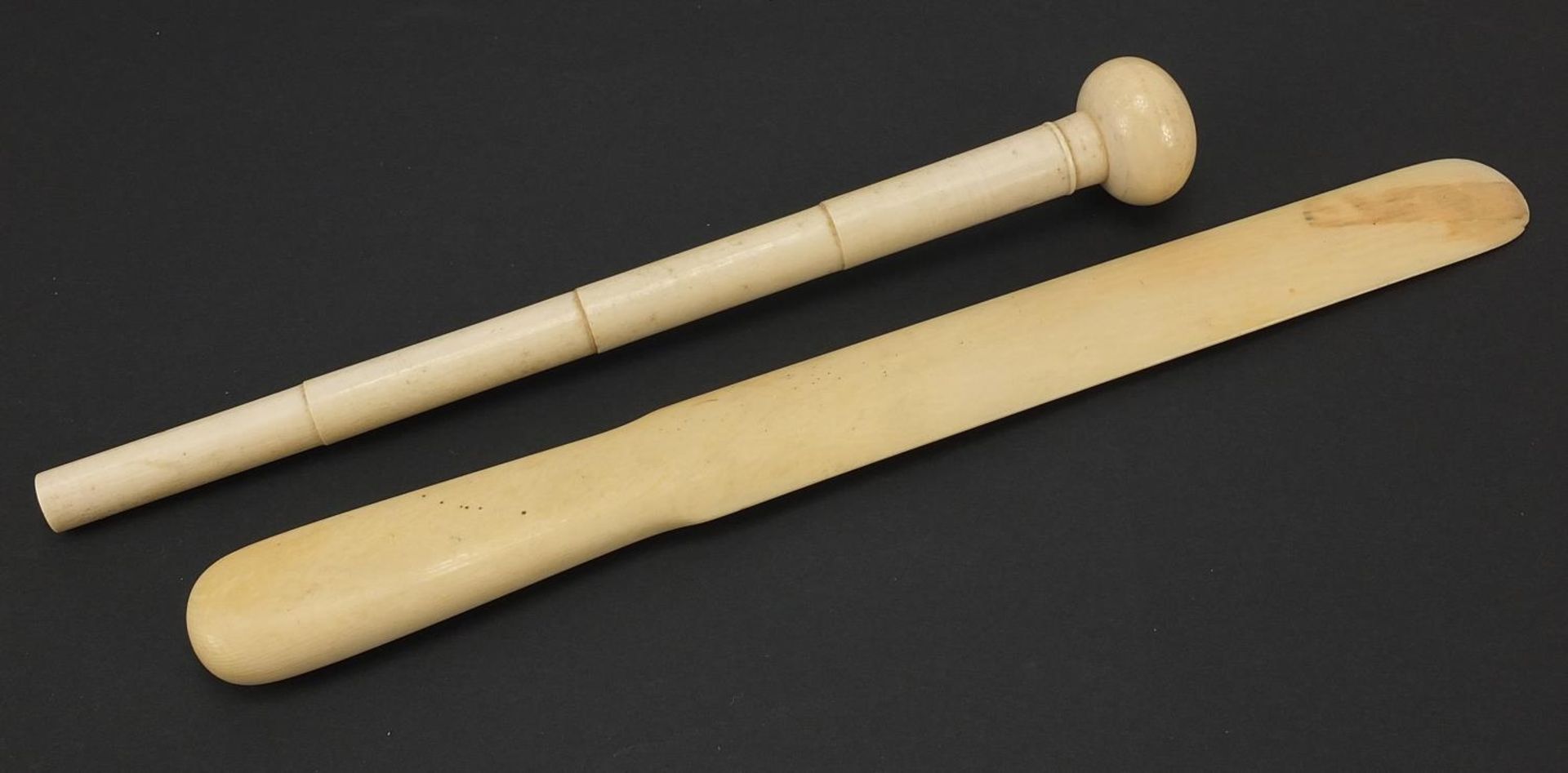 Large ivory page turner and ivory parasol handle, the largest 38cm in length