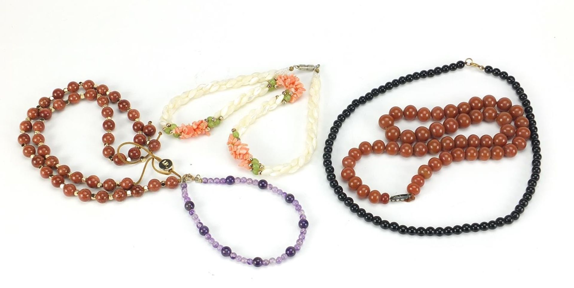 Four necklaces and an amethyst bracelet with 9ct gold clasp including goldstone and carnelian with