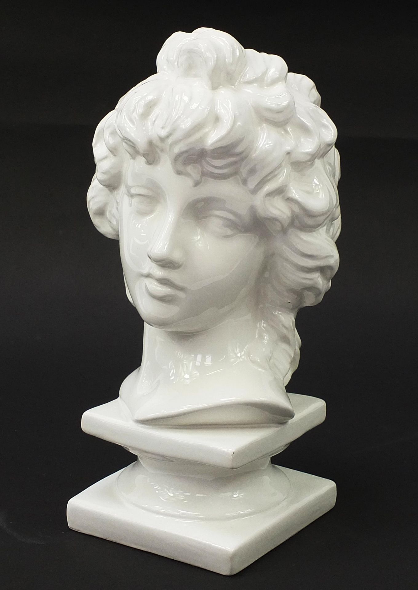 White glazed china bust on plinth of a young female, 40cm high