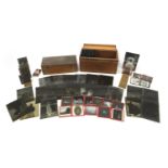 Collection of 19th century social history black and white glass slides arranged in two cases