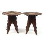 Pair of Anglo Indian carved folding circular tables, 45cm high x 41cm in diameter