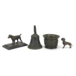 Antique bronzes including hand bell, mortar and two dogs, the largest 14.5cm high