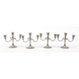 Two pairs of three branch silver plated candelabras, 21cm high