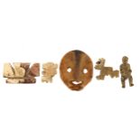 Antiquities including a carved bone face mask, the largest 4cm high