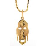 18ct gold tribal mask pendant on an 18ct gold necklace, 3cm high and 48cm in length, 6.0g