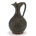 South Italian pottery single handled vessel hand painted with a vine around the neck, 26cm high