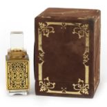 Rectangular brown and gilt scent bottle box with bottle inside having a pierced brass side, the