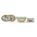Chinese porcelain comprising a Canton wrist rest, blue and white salt and a famille rose bowl, the