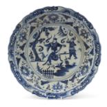 Large Chinese blue and white porcelain charger hand painted with warriors amongst foliage, character