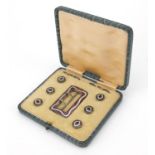 W E Patterson & Co, silver and guilloche enamel buckle and dress studs housed in a fitted box, the