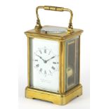 Large French brass cased repeating carriage clock striking on a gong with enamel dial having Roman